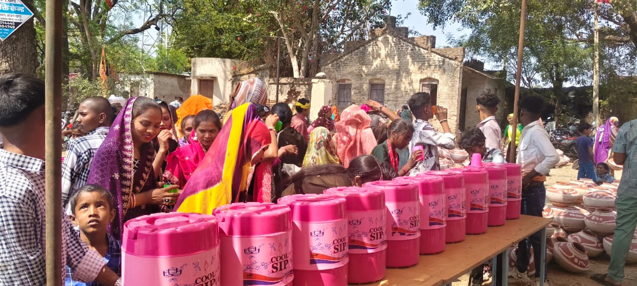 Community members receiving WASH support material